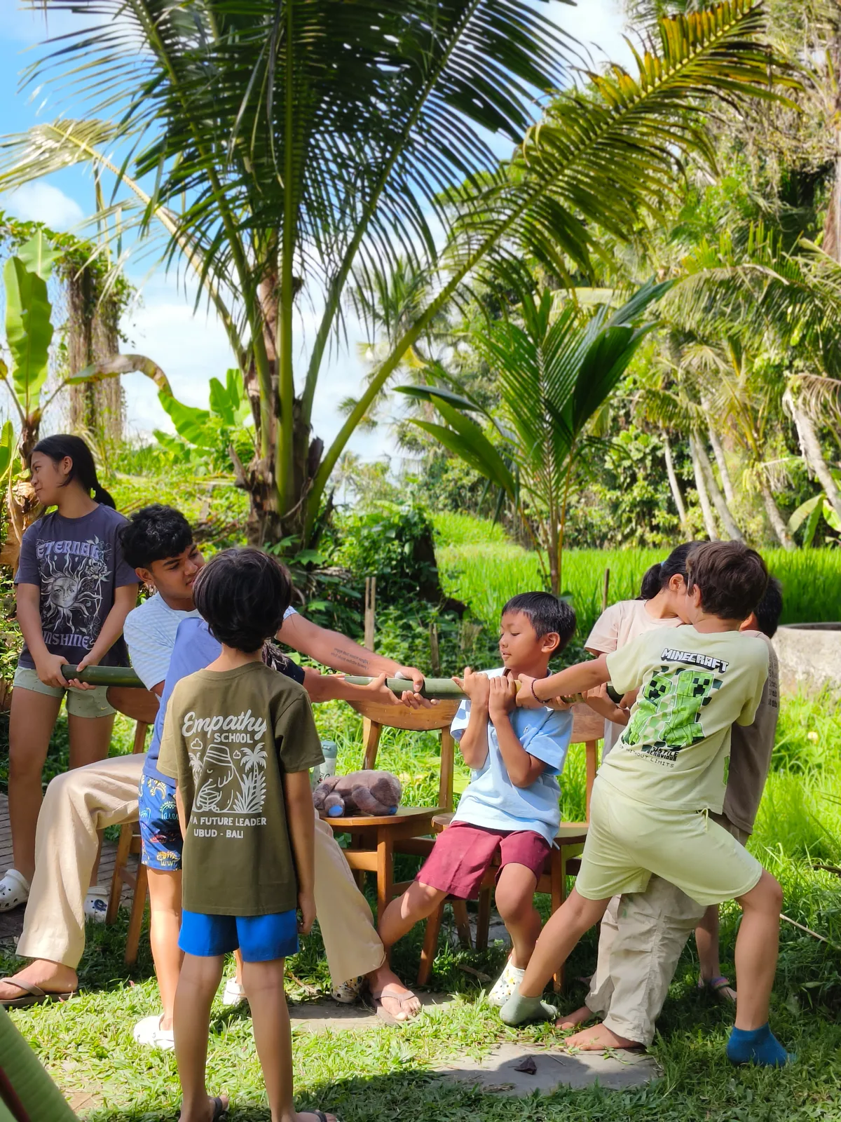 Children and a teacher working with bamboo at Empathy School Bali
