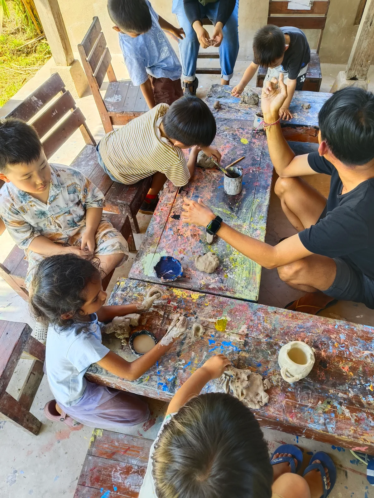Children shaping clay with a teacher at Empathy School Bali