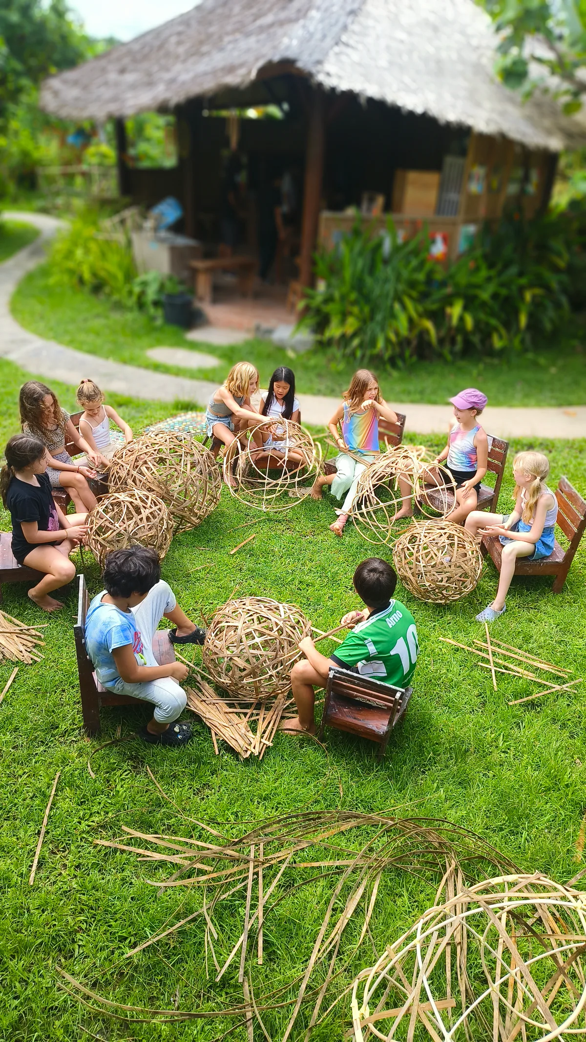 Students building bamboo forms outdoors at Empathy School Bali
