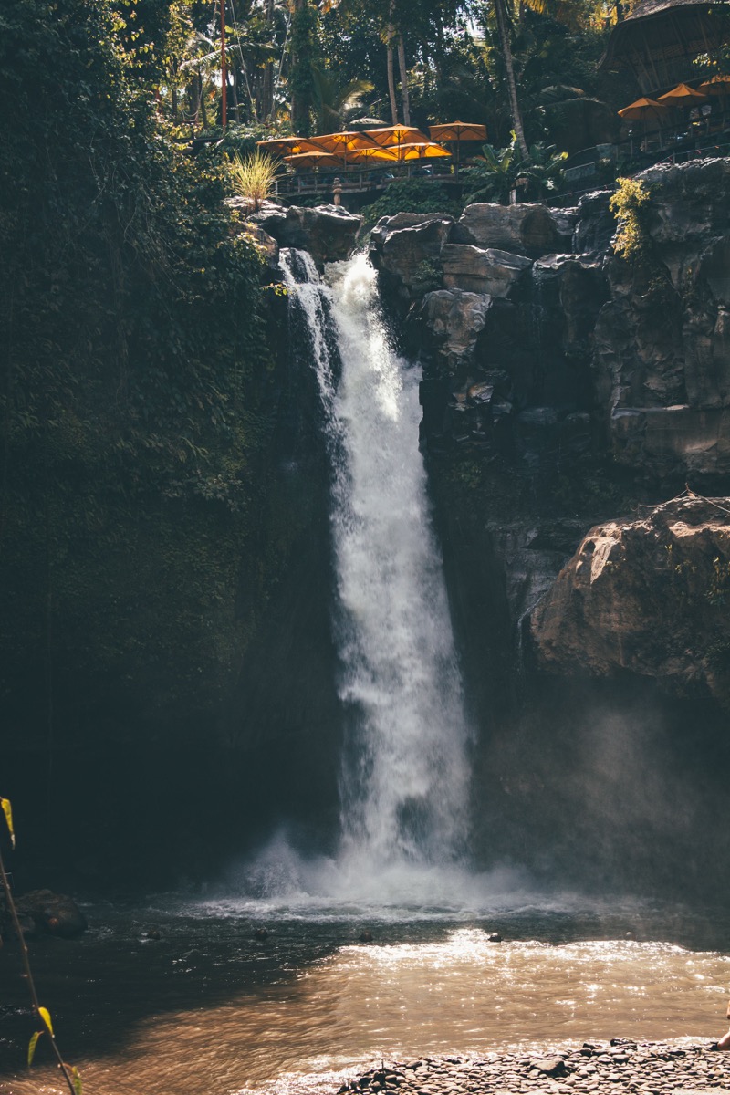 Tibumana waterfall surrounded by forest in Bali